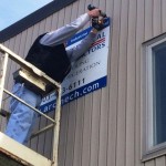 Duane Cook, property manager for Triton Realty, ARC’s landlord, moves ARC’s sign from its old spot closer to our new offices.